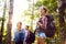 Group of backpacking hikers going for forest trekking