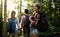 Group of backpacking hikers going for forest trekking