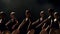 A group of ballerinas dancing on stage in the dark