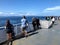 A group of BC Ferry passengers enjoy the beautiful ocean views from the passenger deck, on a beautiful sunny say outside Vancouver