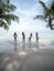 Group of beautiful asian women in bikini posting on tropical sea beach with palm tree. pregnant female traveling with friends for