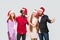 Group of beautiful happy handsome friends in red cap standing an
