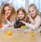 Group of beautiful little girls lying on carpet and playing with bunny.