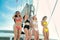 Group of beautiful sexy women are dancing in front of bow of yacht and they look enjoy and fun