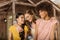 Group of beautiful smiling young women standing embracing on porch