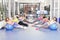 Group of beautiful young women working out on blue pilates balls