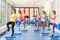 Group of beautiful young women working out on blue stepper.