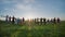 Group of best friends and students jumping outdoors. Sunset with sunshine rays.