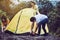 Group of best friends Traveller putting up a tent in nature together,Enjoying camping concept