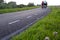 A group of bicyclists touring on a deserted road