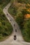 Group of a bikers on the highway between beautiful green tree forest, motorcyclists traveling along mountains road, freedom and