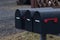 Group of Black mailboxes in front of a house.letterboxes in rainy day before winter