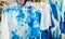 Group of Blue and White Batik T Shirts Design Hanging with Hanger on Rack for Sale in The Market for Summer Season to Wear at The