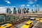 Group of blurred typical yellow New York cabs crossing the Brooklyn Bridge with the Manhattan skyline with blue sky with few cloud