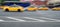 A group of blurred yellow taxicabs in motion in a street.