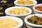 Group of bowls with assorted uncooked pasta