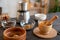 Group of bowls of various sizes with essential oils, coffee beans, dry flowers