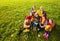 Group of boys and girls on the autumn lawn