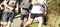 Group of boys running in a park turning to their left