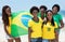 Group of brazilian fans with flag at Copacabana beach at Rio de