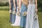 Group of bridesmaids with blue dresses standing in a row