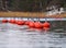 Group of bright red buoys floating in the Baltic Sea on late Autumn overcast day