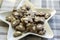 Group of brown moravian dark gingerbreads with sliced almonds, christmas cookies, reindeer shapes on white star shape plate