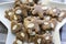 Group of brown moravian dark gingerbreads with sliced almonds, christmas cookies, reindeer shapes on white star shape plate