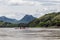 Group of Buddhist monks navigate the Mekong River with a long tail boat in Luang Prabang, Laos