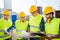 Group of builders with tablet pc and blueprint