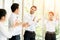 Group of Business applauding while in a meeting at modern office