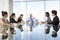 Group Of Business People Having Board Meeting Around Glass Table