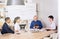 Group of business people laughing together in a conference room