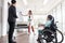 Group of business people in a meeting with colleague, disabled working woman on wheelchair