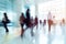 Group Of Business People Moving Quickly Through Bright Office Lobby In Long Exposure Shot