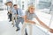 Group of business people pulling rope in office