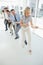 Group of business people pulling rope in office