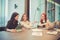 Group of business women meeting in a meeting room with blank screen, sharing their ideas, Multi ethnic