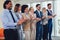 Group of businesspeople clapping in office