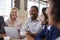 Group Of Businesspeople Having Meeting In Coffee Shop