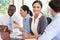 Group Of Businesspeople Meeting Around Boardroom Table