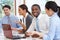 Group Of Businesspeople Meeting Around Boardroom Table