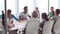 Group Of Businesspeople Meeting Around Boardroom Table