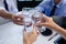 Group of businesspeople toasting glass of water in restaurant