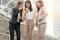 Group businesswoman looking at smartphone in a modern city. Beautiful young woman wearing the business suit using cell phone