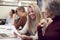 Group Of Businesswomen Collaborating In Creative Meeting Around Table In Modern Office