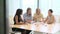 Group Of Businesswomen Meeting Around Desk In Office