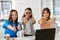 Group of businesswomen showing thumbs up at office