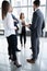 Group of Busy Business People Concept. Business team discussing work in office building hallway.