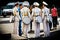 Group of cadets with drums speak with woman